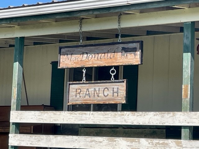 Image of a wooden sign that reads MacDonald Ranch.