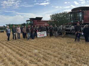 The Huxley/Kneehill North harvest participants pose for a picture with the combines used in the the harvest.