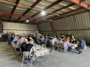 The attendees at the final AFSC Farmer Feed south gathering of harvest 2024 enjoy the meal.