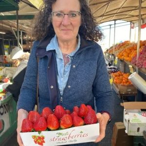 A woman with a box of strawberries