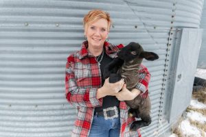 A women holding a goat 