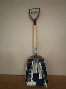 Picture of a silver grain shovel.