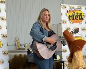 A woman plays guitar.