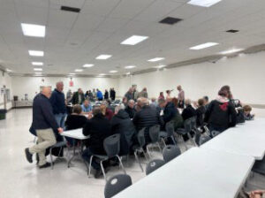 A group of people gathers around a table
